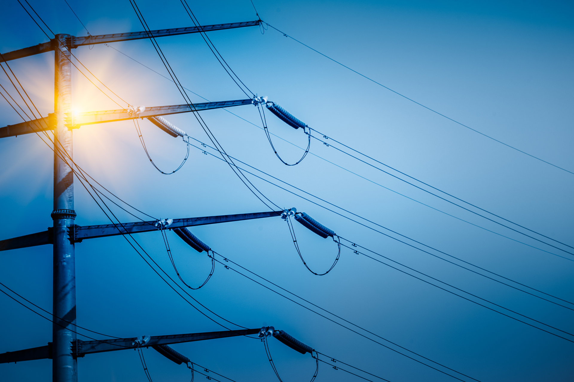 High voltage tower isolated on sky,blue toned.